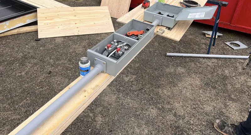 Meter base and service assembly with conduit being built on site