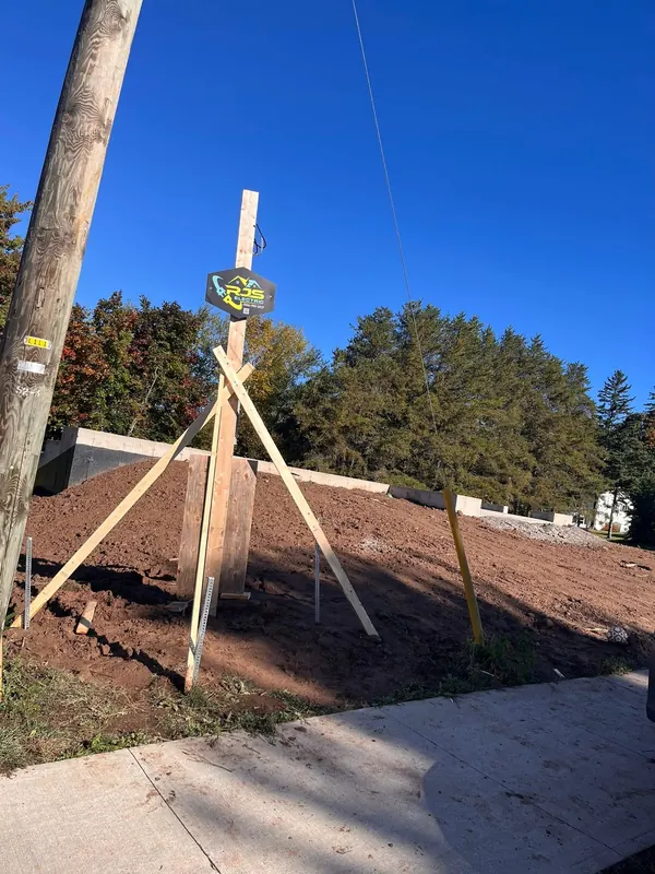 Temporary power service pole with the RJS Electric sign